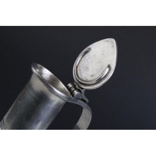 427 - A glass wine decanter with pewter handle.