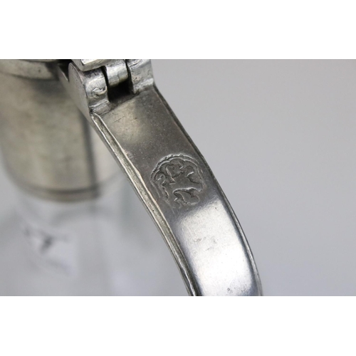 427 - A glass wine decanter with pewter handle.