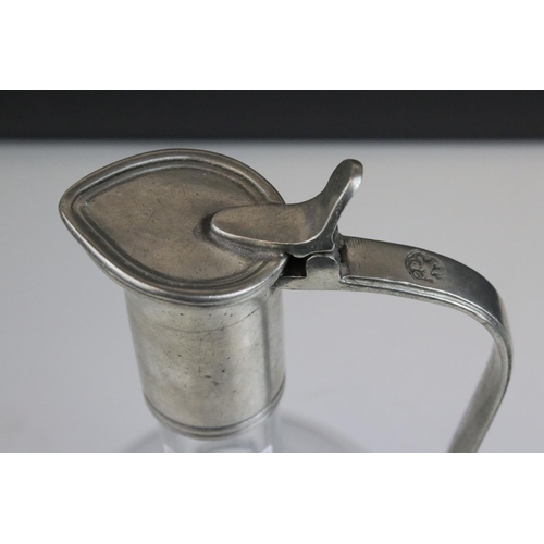 427 - A glass wine decanter with pewter handle.