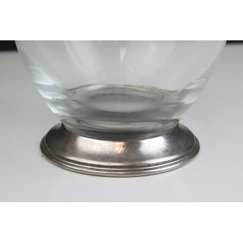 427 - A glass wine decanter with pewter handle.