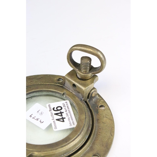 446 - A small brass ships porthole, measures approx 15cm.