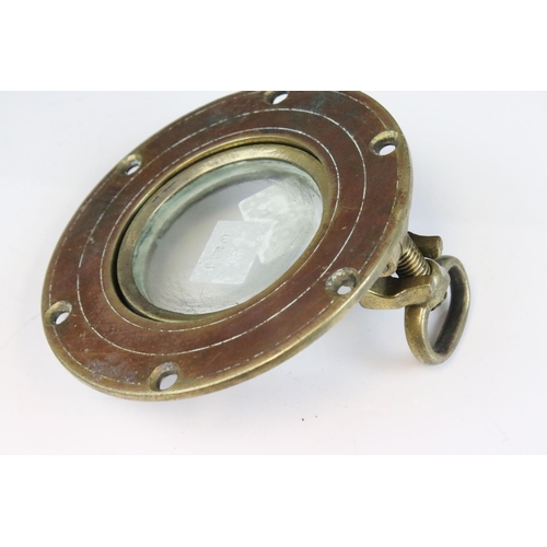 446 - A small brass ships porthole, measures approx 15cm.