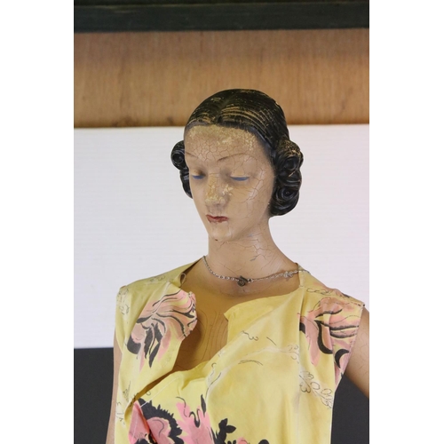 477 - A mid 20th century artist posed model of a lady in dress mounted on plinth.