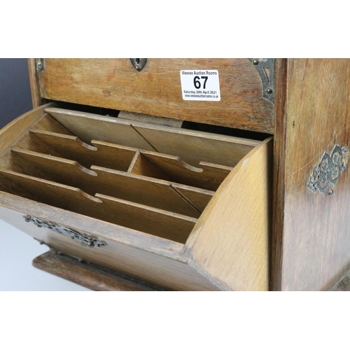 67 - Late 19th century Oak Stationery Cabinet with Brass Mounts, the rising lid with fitted interior also... 