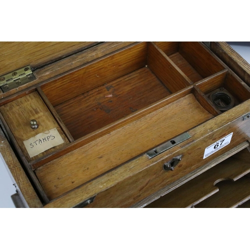 67 - Late 19th century Oak Stationery Cabinet with Brass Mounts, the rising lid with fitted interior also... 