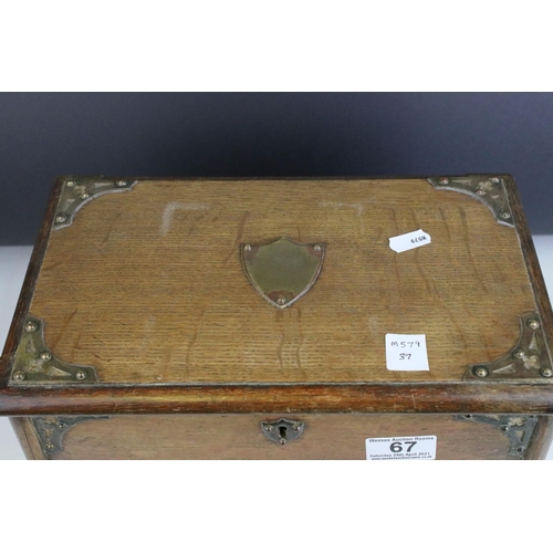 67 - Late 19th century Oak Stationery Cabinet with Brass Mounts, the rising lid with fitted interior also... 