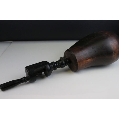 86 - Carved Wooden Man's Head mounted on a turned ebonised clamp. 53cms high