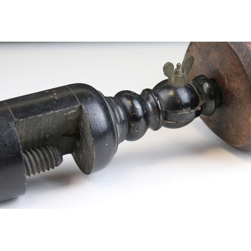 86 - Carved Wooden Man's Head mounted on a turned ebonised clamp. 53cms high