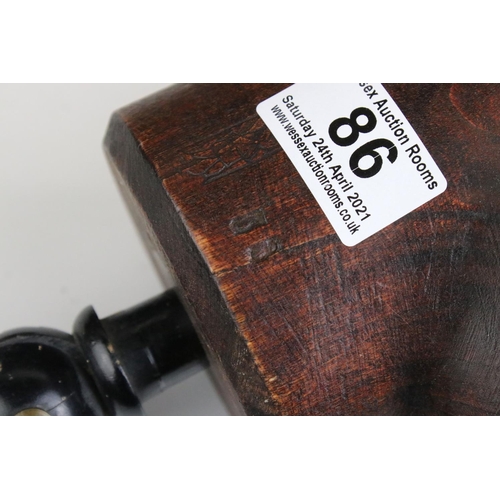 86 - Carved Wooden Man's Head mounted on a turned ebonised clamp. 53cms high