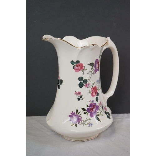 388 - A vintage ceramic wash basin and jug together with two Clarice Cliff Bizarre pattern platters.