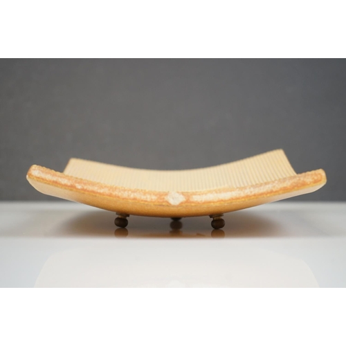 401 - A contemporary pottery bowl of square form decorated in the style of Pablo Picasso with indistinct s... 