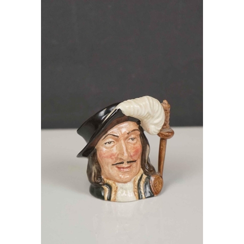 417 - A collection of four Royal Doulton character jugs together with a Royal Doulton toby jug.