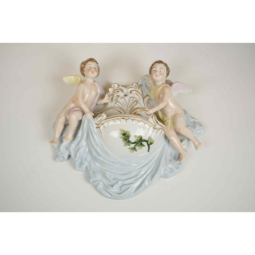 421 - A Sitzendorf wall pocket with cherub Decoration, two floral wall pockets, a ceramic art pottery bowl... 