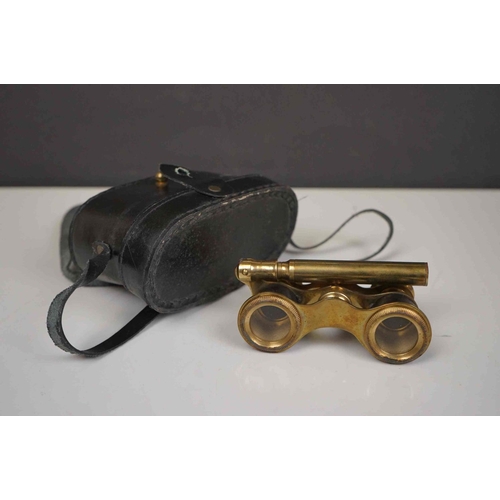 422 - A collection three pairs of modern binoculars together with a pair of opera glasses.