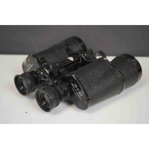 422 - A collection three pairs of modern binoculars together with a pair of opera glasses.