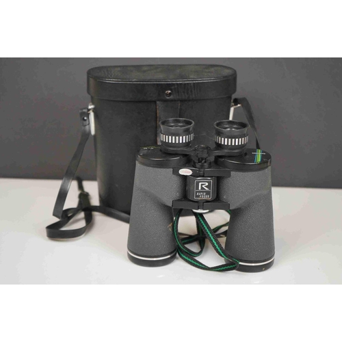 422 - A collection three pairs of modern binoculars together with a pair of opera glasses.