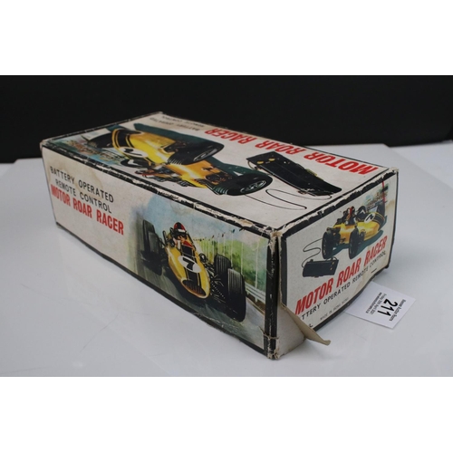 211 - Boxed Battery Operated r/c Motor Roar Racer plastic car, in yellow, with driver, gd overall, box fai... 