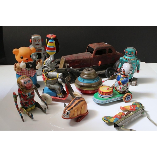 228 - Collection of ten tin plate toys, to include clockwork car,  robots, mouse photographer, elephant on... 