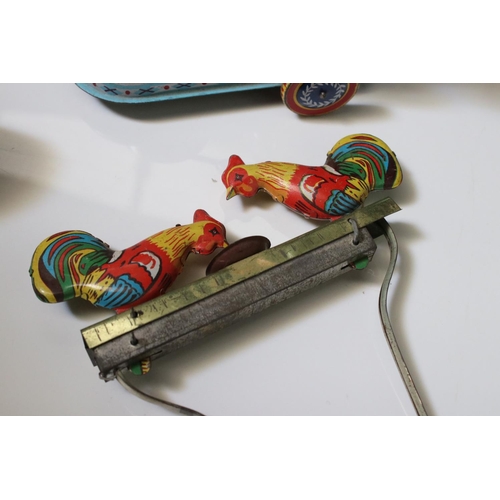 228 - Collection of ten tin plate toys, to include clockwork car,  robots, mouse photographer, elephant on... 