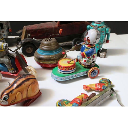 228 - Collection of ten tin plate toys, to include clockwork car,  robots, mouse photographer, elephant on... 