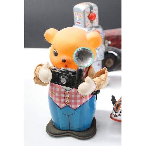 228 - Collection of ten tin plate toys, to include clockwork car,  robots, mouse photographer, elephant on... 