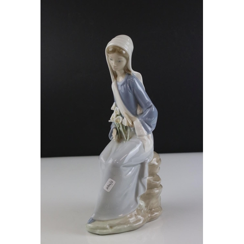 16 - Lladro figure of a lady sitting on rocks with calla lilies in her lap