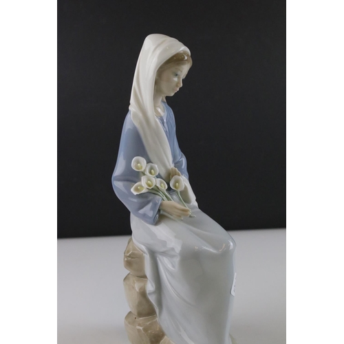 16 - Lladro figure of a lady sitting on rocks with calla lilies in her lap