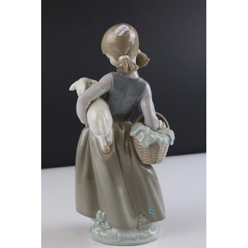 17 - Lladro figure 4835, girl with a lamb in her arms and carrying a basket