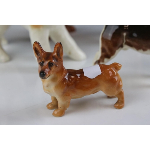 24 - Four Beswick Dogs including Corgi, Beagle, Cocker Spaniel and Terrier, walking