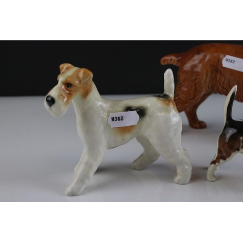 24 - Four Beswick Dogs including Corgi, Beagle, Cocker Spaniel and Terrier, walking