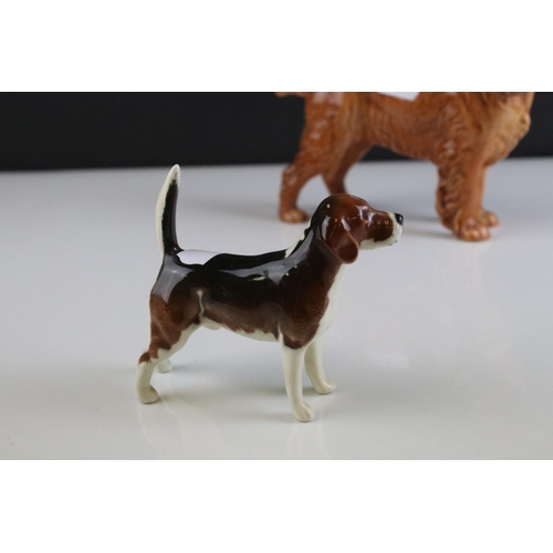 24 - Four Beswick Dogs including Corgi, Beagle, Cocker Spaniel and Terrier, walking