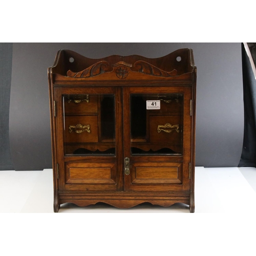 41 - Early 20th century Oak Table Top Smoker's Cabinet, the two glazed doors opening to a fitted interior... 