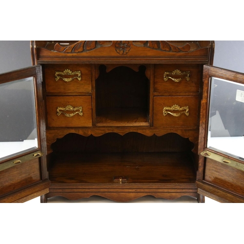 41 - Early 20th century Oak Table Top Smoker's Cabinet, the two glazed doors opening to a fitted interior... 