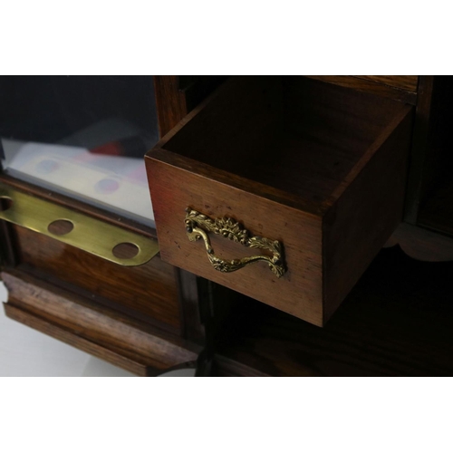 41 - Early 20th century Oak Table Top Smoker's Cabinet, the two glazed doors opening to a fitted interior... 