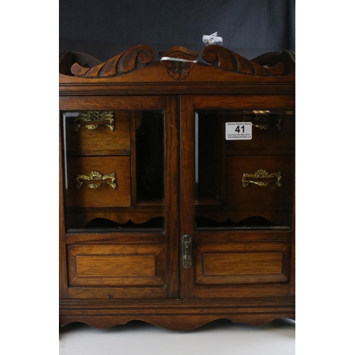 41 - Early 20th century Oak Table Top Smoker's Cabinet, the two glazed doors opening to a fitted interior... 