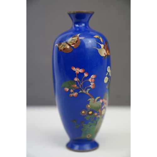 184 - An Oriental blue enamel vase with butterfly and floral decoration. Part of an extensive collection o... 