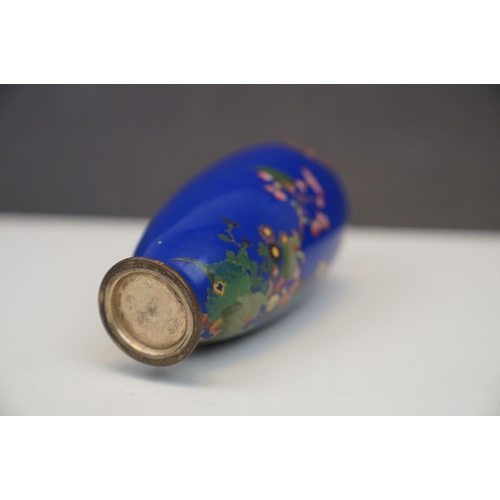 184 - An Oriental blue enamel vase with butterfly and floral decoration. Part of an extensive collection o... 