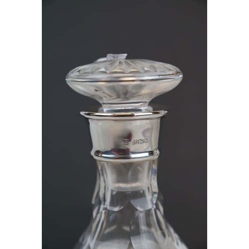 192 - Two glass decanters with fully hallmarked sterling silver collars to include a ships decanter.