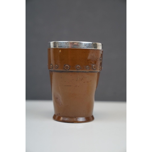 193 - A Doulton Silicon antique silver mounted beaker in the form of a studded copper cup.