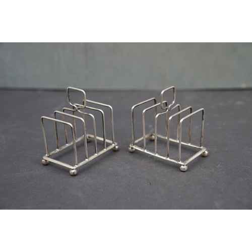 196 - A pair of fully hallmarked sterling silver toast racks, maker marked for William Hutton & Sons, Birm... 