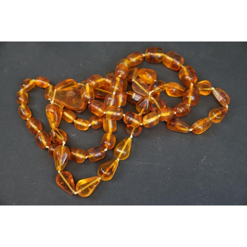 213 - Large quantity of amber style necklaces and bracelets