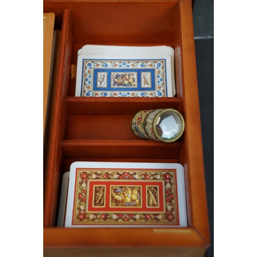 223 - A cased Bridge set to include playing cards, score books and pens contained within a book shaped box... 