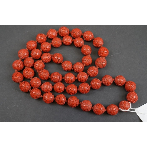 250 - A vintage Chinese Cinnabar beaded necklace with floral decoration.