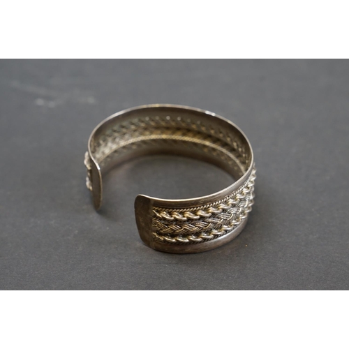 254 - A hallmarked 9ct gold bangle bracelet together with a selection of silver and white metal examples.