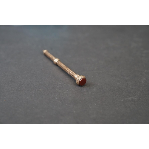 264 - Two hallmarked 9ct gold propelling pencils to include one with carnelian top.