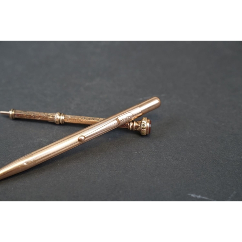 264 - Two hallmarked 9ct gold propelling pencils to include one with carnelian top.