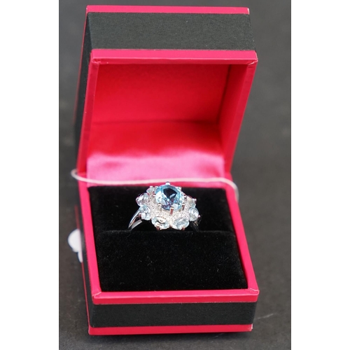 269 - Silver and blue topaz dress ring set with CZs, stamped 925