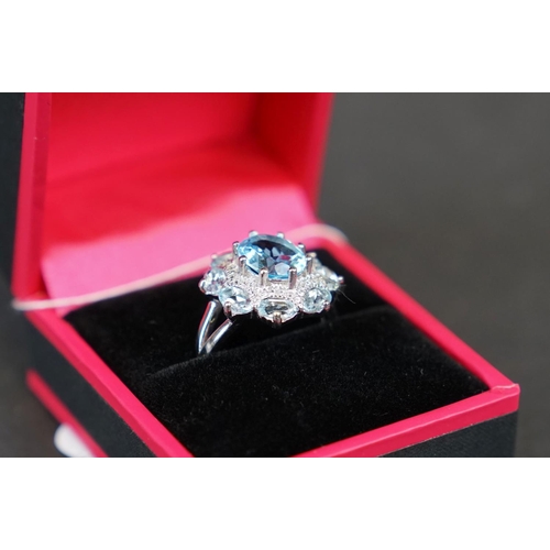 269 - Silver and blue topaz dress ring set with CZs, stamped 925