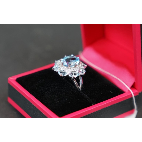 269 - Silver and blue topaz dress ring set with CZs, stamped 925