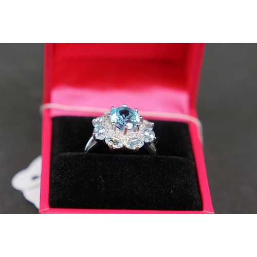 269 - Silver and blue topaz dress ring set with CZs, stamped 925